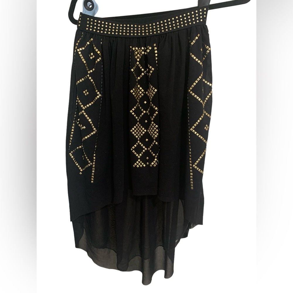 Black high low skirt with gold stud pattern.